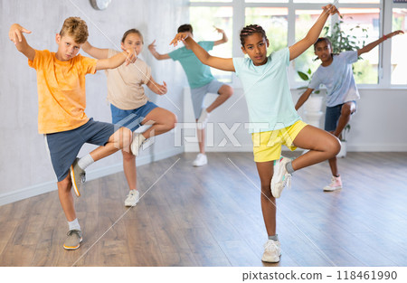 Group of positive juvenile boys and girls engaged in Breakdancing in training room 118461990