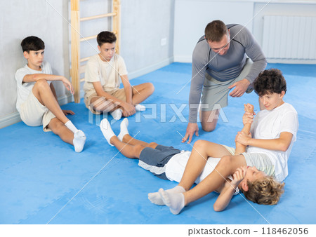 Adolescent boys working on kimura maneuver during self-defense course Adolescent boys working on kimura maneuver during self-defense course 118462056