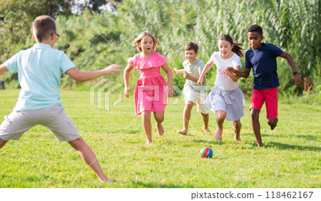 Boys and girls playing football outdoors Boys and girls playing football outdoors 118462167
