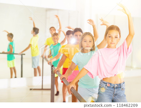 Youth girls and boys training ballet moves in studio Youth girls and boys training ballet moves in studio 118462209
