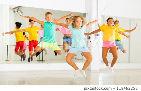 Kids jumping together in studio 118462258