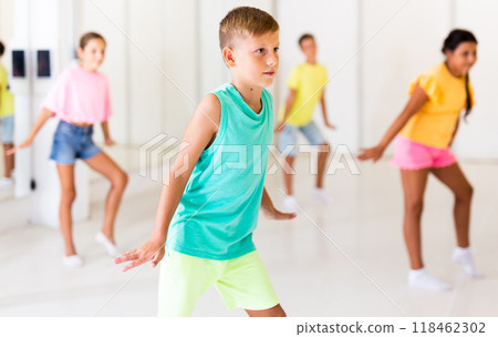 Group children learn dance movements in class 118462302