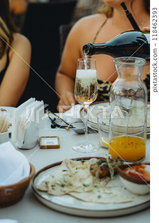Hand pouring wine to the glasses close-up The waiter pours pink sparkling wine 118462393