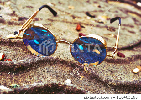 Vintage cool gold sunglasses with blue lenses on rusty iron Vintage cool gold sunglasses with blue lenses on rusty iron 118463163