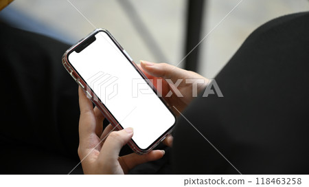 Close up shot of young man holding smartphone with white empty screen 118463258