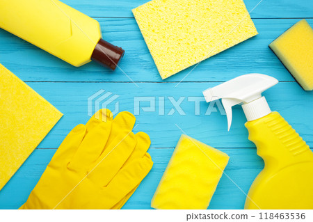 Cleaning Set. Yellow tools for cleaning. Cleaning agents, spray, rubber gloves on blue background. Cleaning Set. Yellow tools for cleaning. Cleaning agents, spray, rubber gloves on blue background. 118463536