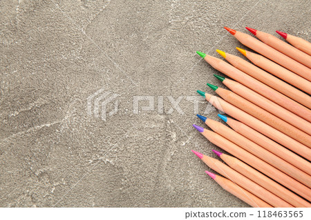 Colored pencils on the grey background. Top view. Colored pencils on the grey background. Top view. 118463565