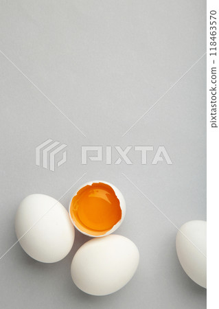 White eggs and egg yolk on the grey background. Easter concept White eggs and egg yolk on the grey background. Easter concept 118463570