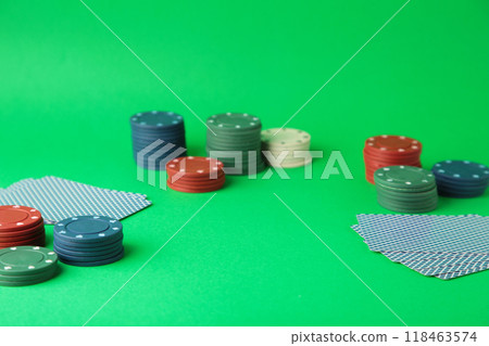 Gambling chips and card for poker on green background 118463574