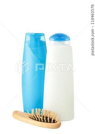 White and blue shampoo bottle with wooden combon isolated on white background. White and blue shampoo bottle with wooden combon isolated on white background. 118463576