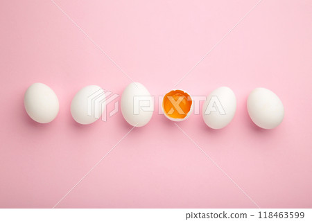 White eggs and egg yolk on the pink background. Easter concept White eggs and egg yolk on the pink background. Easter concept 118463599