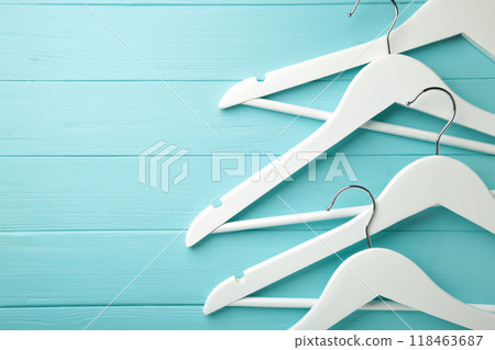 Many wooden white hangers on grey background. 118463687