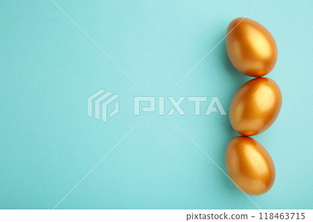 Gold Easter eggs on blue background. Spring concept. Gold Easter eggs on blue background. Spring concept. 118463715