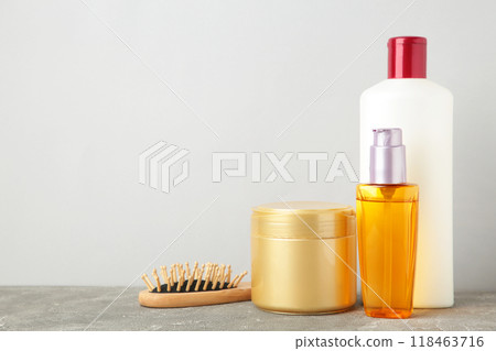 A lot of different cosmetic products for hair care on grey A lot of different cosmetic products for hair care on grey 118463716