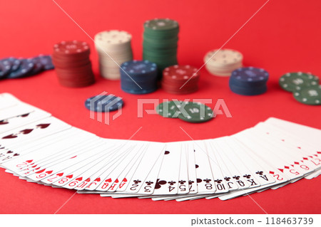 Gambling chips and card for poker on red background 118463739