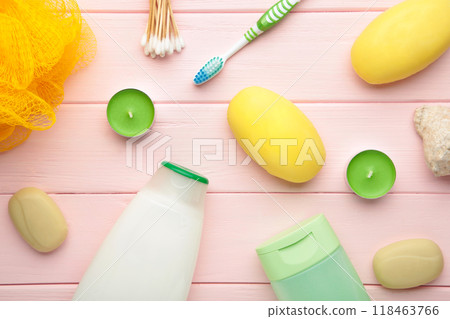 Shampoo, soap, aroma candles and other toiletry. Spring composition on pink background 118463766