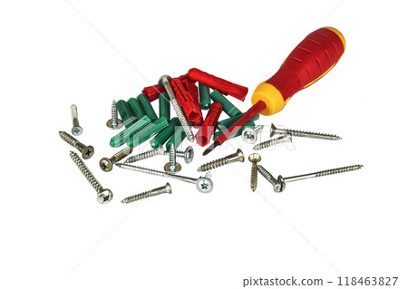 Screwdriver, screws and plastic dowels on a light background 118463827