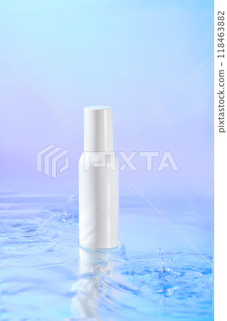A minimalist photo of a sleek white spray bottle, promoting skincare or beauty products, is displayed on a clear blue water surface with a soft gradient of blue and purple background. 118463882