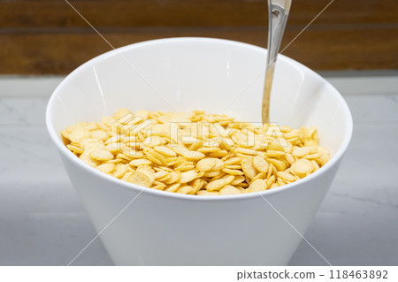 Cornflakes on a White Plate - Side View Cornflakes on a White Plate - Side View 118463892
