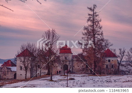 Winter Sunset Over the Historic Castle Ruins in a Serene, Snowy Landscape. Winter Sunset Over the Historic Castle Ruins in a Serene, Snowy Landscape. 118463965