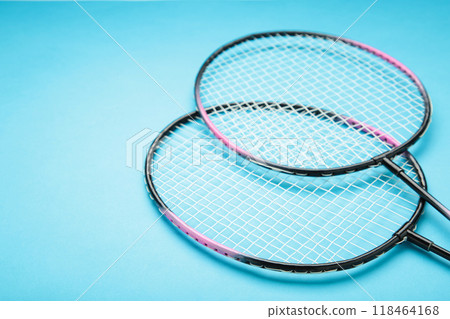 Rackets on blue bacjground, flat lay with space for text. Badminton equipment Rackets on blue bacjground, flat lay with space for text. Badminton equipment 118464168