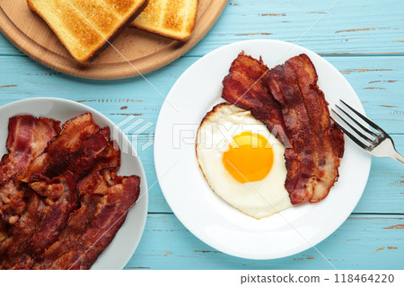 Eggs and bacon for breakfast on blue background. English breakfast with copy space. 118464220