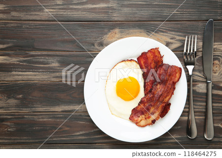 Eggs and bacon for breakfast on brown background. English breakfast with copy space for text Eggs and bacon for breakfast on brown background. English breakfast with copy space for text 118464275