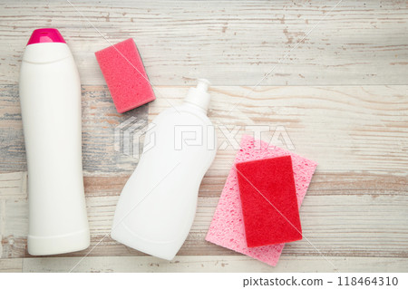 Cleaning Set. Yellow and white tools for cleaning. Cleaning agents, spray, rubber gloves on grey wooden floor background. 118464310