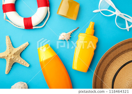Sunscreen bottle with hat, glasses and other accessories on blue background. Cosmetics for safe sunburn. Top view, flatlay. Sun protection cream Sunscreen bottle with hat, glasses and other accessories on blue background. Cosmetics for safe sunburn. Top view, flatlay. Sun protection cream 118464321