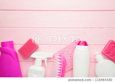 Cleaning Set. Pink and white tools for cleaning. Cleaning agents, spray, rubber gloves on pink background. Cleaning Set. Pink and white tools for cleaning. Cleaning agents, spray, rubber gloves on pink background. 118464380