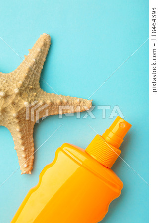 Sun protection bottle with starfish on blue background. Vertical foto. Sun protection bottle with starfish on blue background. Vertical foto. 118464393