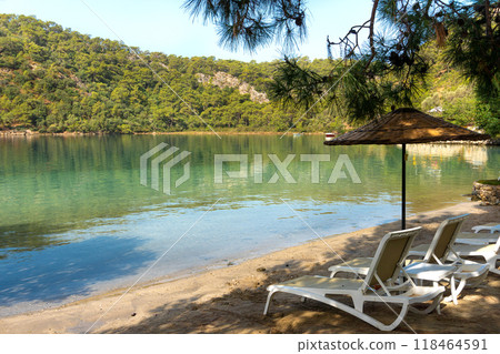 View of Blue Lagoon with Sun Loungers and Umbrellas at a Tropical Resort in Oludeniz, Turkey 118464591