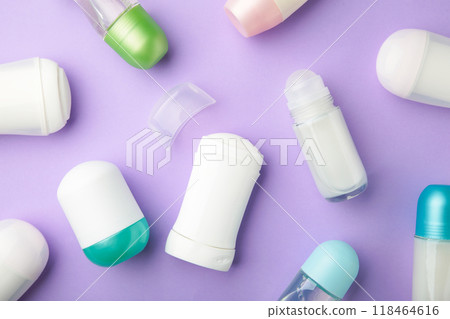 Different antiperspirant deodorant with cotton on purple background. Skin care concept. copy space, top view Different antiperspirant deodorant with cotton on purple background. Skin care concept. copy space, top view 118464616