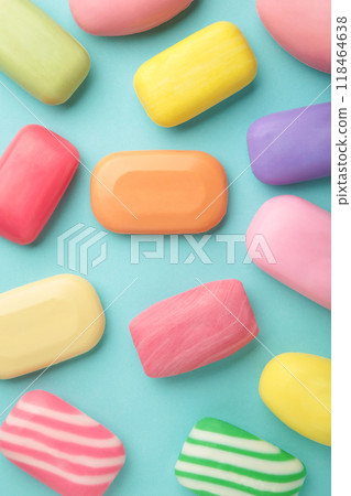 Different soaps in different soap dishes. A lot of solid soap for hygiene and cleanliness. Colorful soap and remnants are scattered on blue background. Different soaps in different soap dishes. A lot of solid soap for hygiene and cleanliness. Colorful soap and remnants are scattered on blue background. 118464638