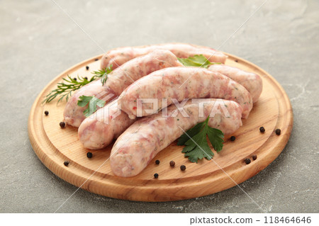 Raw sausage on cutting board on grey background. Top view 118464646