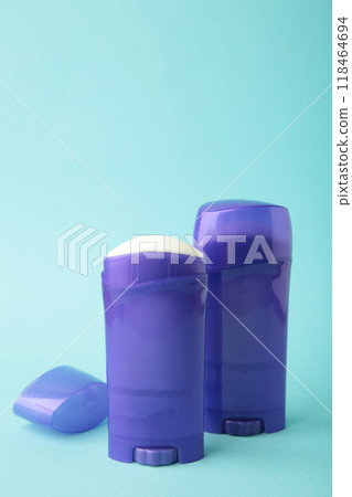 Violet antiperspirant deodorant on blue background. Skin care concept. copy space, top view 118464694