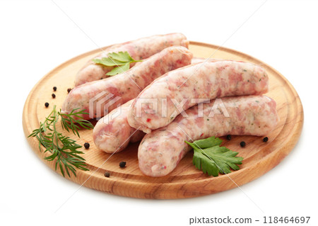 Raw sausages on cutting board isolated on white. Raw sausages on cutting board isolated on white. 118464697