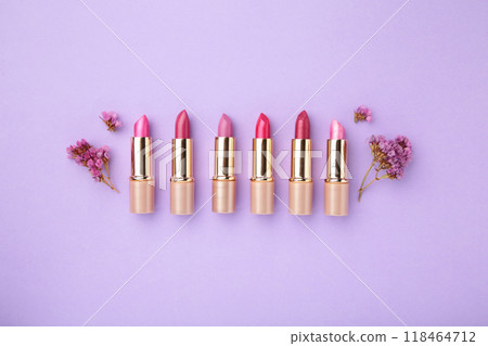 Lipstick with beautiful flowers on purple background Lipstick with beautiful flowers on purple background 118464712