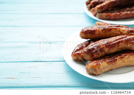 Roasted sausage on plate on blue background with copy space Roasted sausage on plate on blue background with copy space 118464734