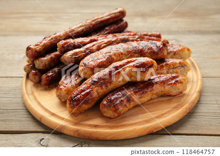 Grilled sausages on wooden board on grey background 118464757