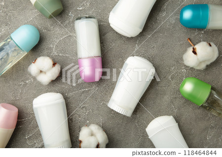 Different deodorants with cotton on grey background. 118464844