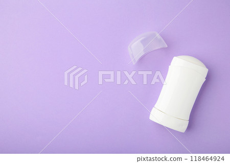 White antiperspirant deodorant on purple background. Skin care concept. copy space, top view White antiperspirant deodorant on purple background. Skin care concept. copy space, top view 118464924