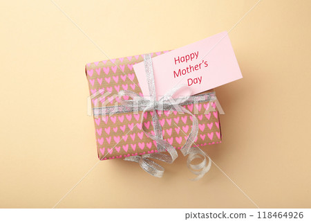 Mother's day card on beige background with a present. Happy Mother's day Mother's day card on beige background with a present. Happy Mother's day 118464926