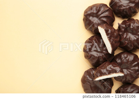 Chocolate covered marshmallows on beige background with copy space. Minimalism 118465106