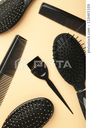 Hair tools, beauty and hairdressing concept - different brushes or combs on beige background. Vertical photo Hair tools, beauty and hairdressing concept - different brushes or combs on beige background. Vertical photo 118465109