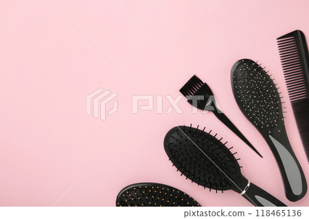 Hair tools, beauty and hairdressing concept - different brushes or combs on pink background Hair tools, beauty and hairdressing concept - different brushes or combs on pink background 118465136