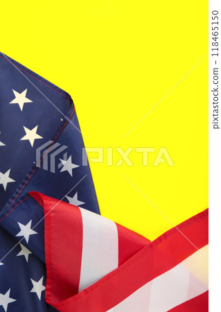 American flag on yellow background with copy space. Vertical photo American flag on yellow background with copy space. Vertical photo 118465150