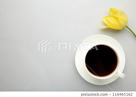 Cup of coffee with yellow tulip on grey background with copy space 118465162
