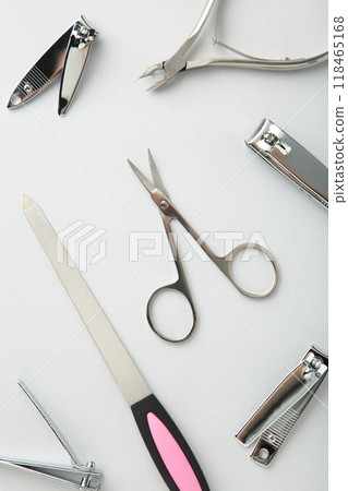 Tools of a manicure set on grey background. Vertical photo Tools of a manicure set on grey background. Vertical photo 118465168