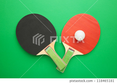 Ping pong rackets and balls on green background. Ping pong rackets and balls on green background. 118465181